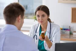 doctor prescribing patient with medication in rehab