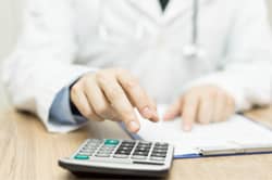 A doctor calculates the cost of partial hospitalization